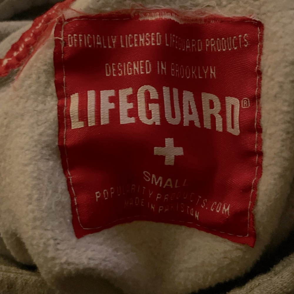 Size Small ,  the sweatshirt is a light Grey, with white and red in colors.